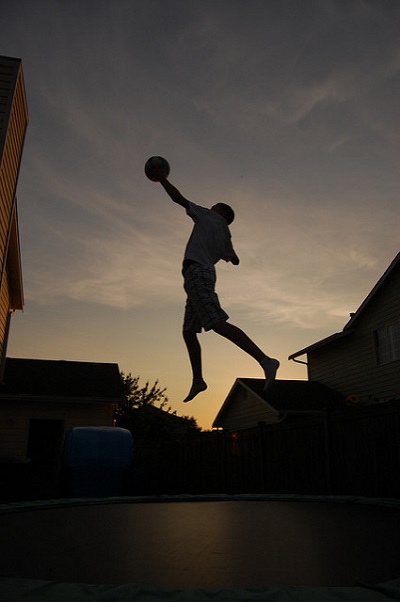 boy-with-trampoline-accessory-basketball-ring