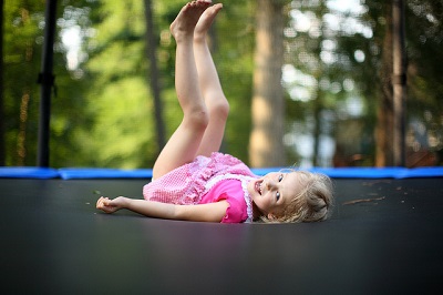smiling-underage-little-girl-on-trampoline