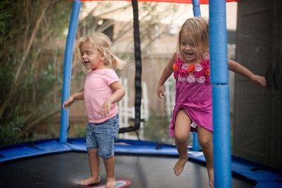 toddlers-on-trampoline-twin-girls